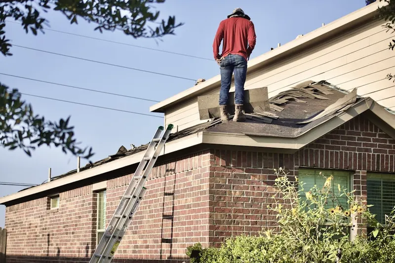 Professional roofer working on a residential roof in Stop 6